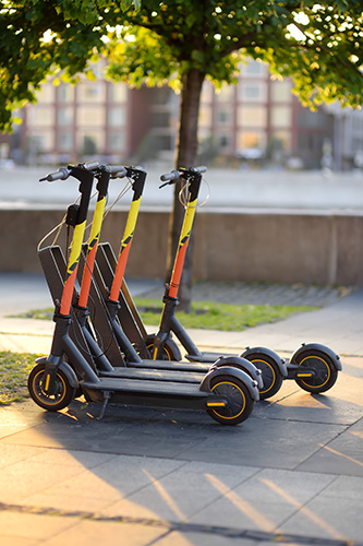 rentable electric scooters on sidewalk